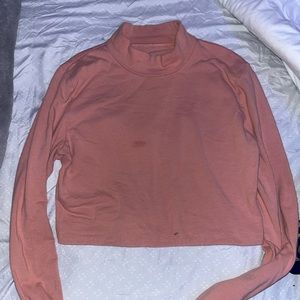 Turtle neck pink shirt.